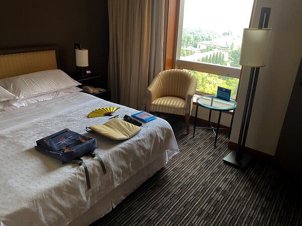 Keith Bradsher’s hotel room in Beijing, with the knapsack made for the centenary perched on the bed.