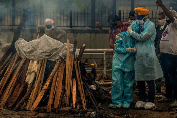 Jitender Singh Shunty, right, whose organization runs the Seemapuri  cremation grounds in New Delhi, said that about 100 bodies arrived every day.