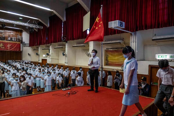 A flag-raising ceremony on National Security Education Day in Hong Kong in April. Schoolchildren are now being taught to watch for dissent.