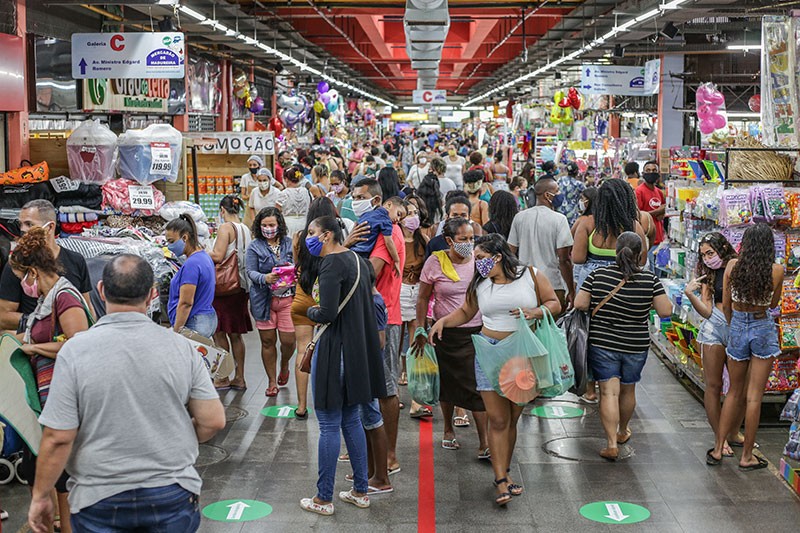Shoppers wearing face masks walk in a crowded Mercadao de Madureira in Rio de Janeiro, Brazil.