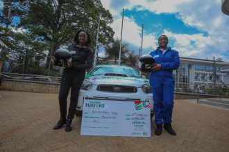 Rally Driver Maxine Wahome (R) and her co-driver Linet Ayuko (L) pose for a picture after Safaricom’s sponsorship cheque handover - Bizna Kenya