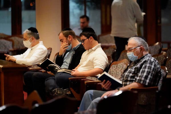 People prayed at the Shul of Bal Harbour in Surfside, Fla., on Thursday. Members of the community were reported missing in the partial collapse of the Champlain Towers South condominium.
