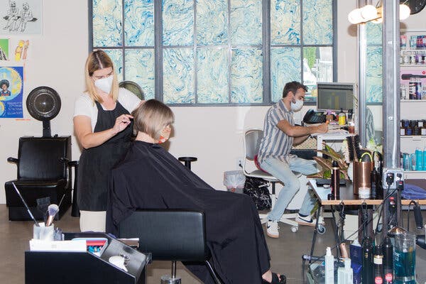The Lucas Salon in Los Angeles in July. As coronavirus cases fueled by the Omicron variant drop in the United States, some officials say that Americans will have to grapple more with how to live with the virus.