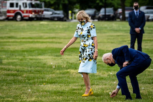 President Biden stopped to pick a dandelion for Jill Biden, the first lady, while departing the White House on Thursday.