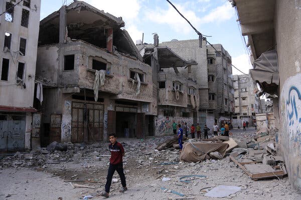 A young man walks among the rubble of a house in Gaza destroyed by Israeli warplanes on Monday.