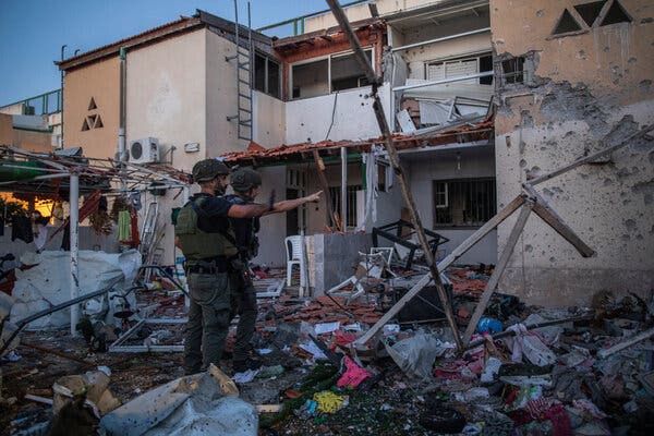 Israeli troops responded to rocket attacks from militants with airstrikes, like the one that hit this house in Gaza. In Israel, Jewish and Arab mobs rioted in the streets.
