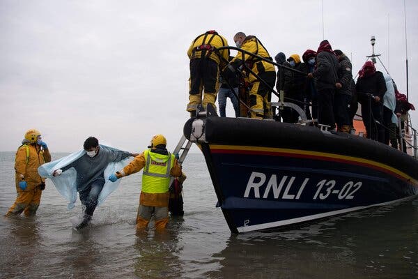 Migrants from another boat were rescued by the Royal National Lifeboat Institution and brought to Dungeness, on the southeast coast of England, on Wednesday.