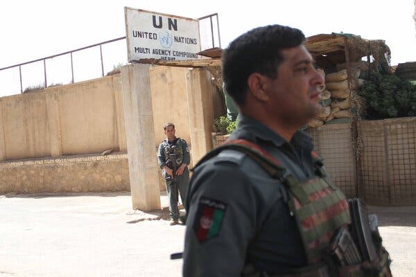 Afghan security officials standing guard outside the U.N. office in Herat after it was attacked in July.