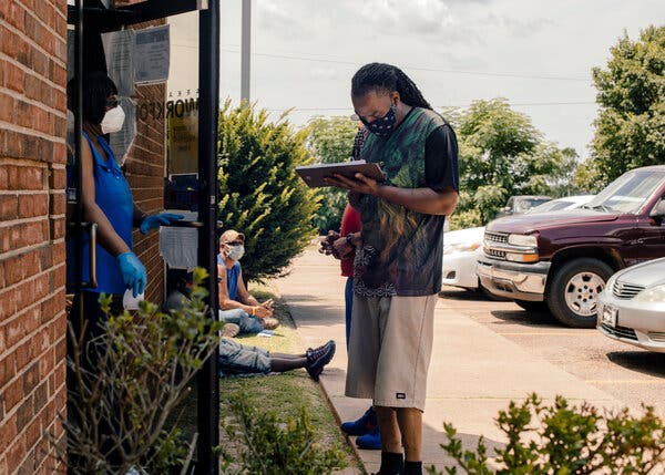 Applying for unemployment benefits in Helena, Ark. The persistently high level of new claims reflects the continuing damage to the labor market from the coronavirus pandemic.