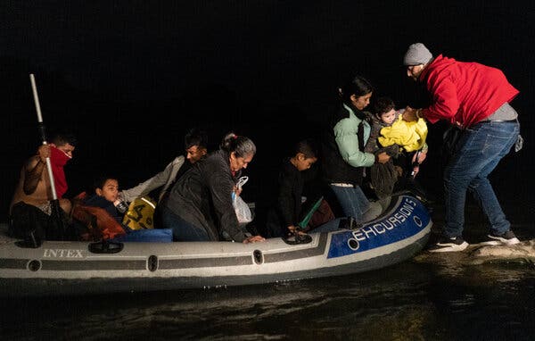Asylum-seeking migrants’ families climbed out of an inflatable raft used to cross the Rio Grande River into the United States from Mexico last month, landing in Roma, Texas.