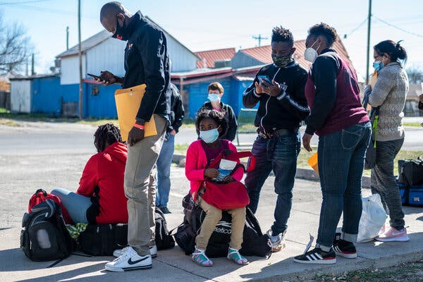 Migrants wait to be processed at a migrant shelter in March, in Del Rio, Texas.