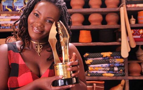 Former KTN actress Ruth Maingi holding an award.