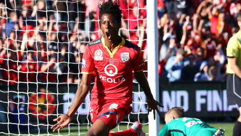An image of Bruce Kamau Celebrating after scoring a goal.