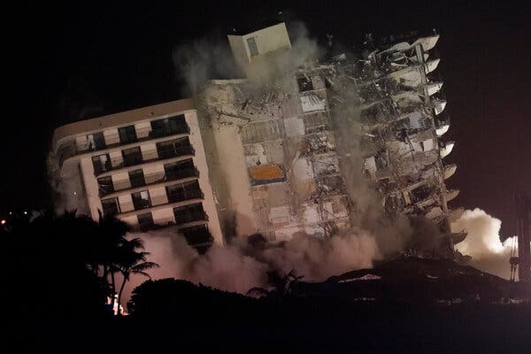 The part of the Champlain Towers South condominium building that was still standing was demolished late Sunday in Surfside, Fla.