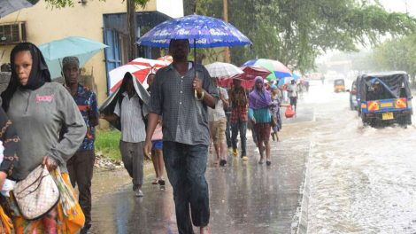 Mombasa residents walk to work in the rain 