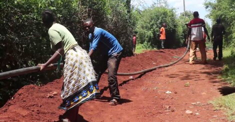 Residents of two villages in Kandara Sub County dig trenches for a government project