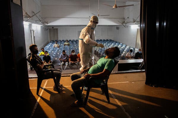 A health worker administers a Covid-19 test in Gauhati, India, on Saturday.