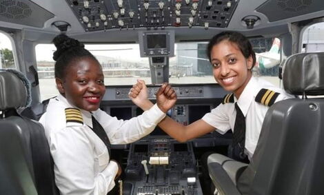 An Image of Two Pilots in an Aeroplane Cockpit.