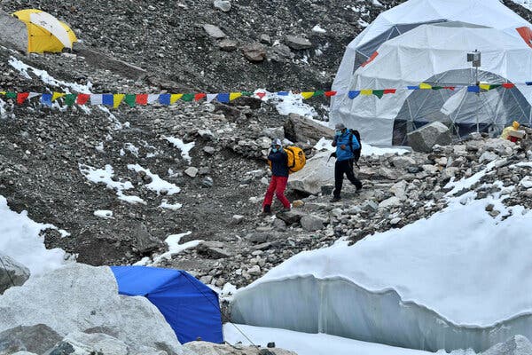 Expedition members wearing face masks at Mount Everest base camp on May 1. A prominent mountaineering company abandoned its summit expedition on Saturday after more climbers were found to be infected with the coronavirus.