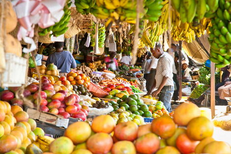 Traders and customers pictured at a market in Kenya.