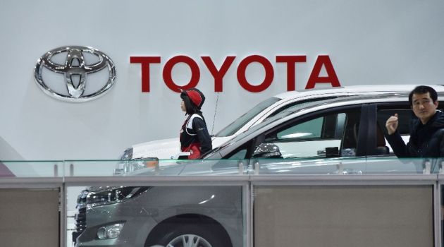 Toyota posts record full-year net profit, forecasts cautious