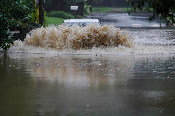 A car driving through flood waters near Atlanta on Tuesday as the remnants of Tropical Storm Fred made their way through the region.