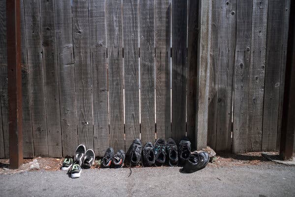 Shoes sitting outside Karla Lorenzo’s home to disinfect. She confined herself to the closet for days to avoid spreading the virus to her children.