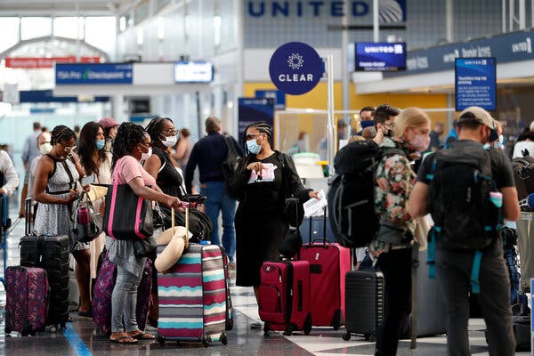 People waited in line at O’Hare airport in Chicago on Thursday, ahead of the Fourth of July holiday weekend.