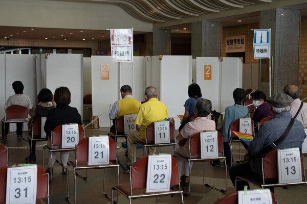Older people waiting to receive a coronavirus vaccine in Tokyo on Monday.