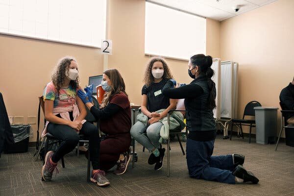 Teen twins Kira and Nola Barth receive the coronavirus vaccine in Nashville, Tennessee.
