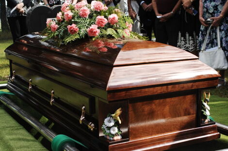 A casket being lowered into the ground