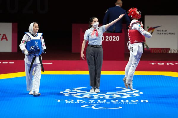 Zakia Khudadadi of Afghanistan, in blue, during her bout with Viktoriia Marchuk of Ukraine on Thursday.