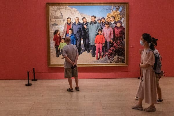 Visitors in front of a portrait of Xi Jinping at the National Art Museum during the exhibition “100 years toward greatness” on Wednesday.