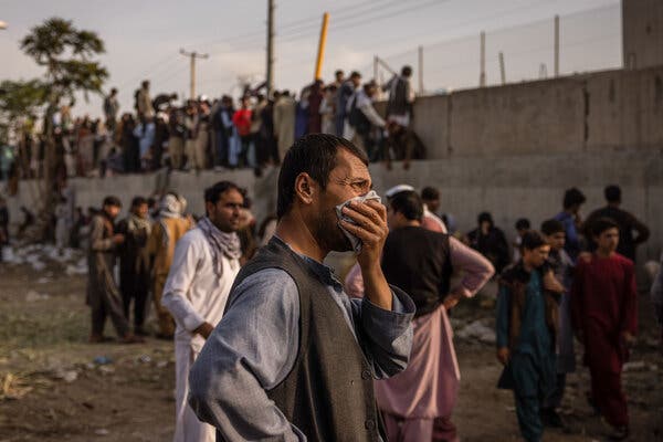 A crowd waits near an entrance to the international airport in Kabul in August.