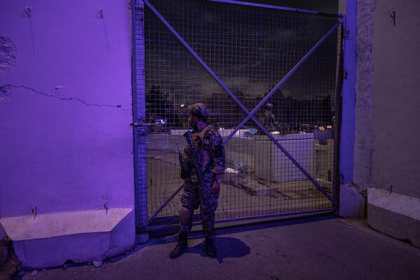 A member of the Taliban’s Badri 313 Battalion guarding a gate at the Kabul airport on Saturday.