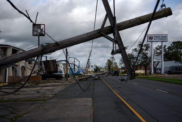 A downed utility pole blocking part of a roadway in Houma, La., on Monday after Hurricane Ida passed through.