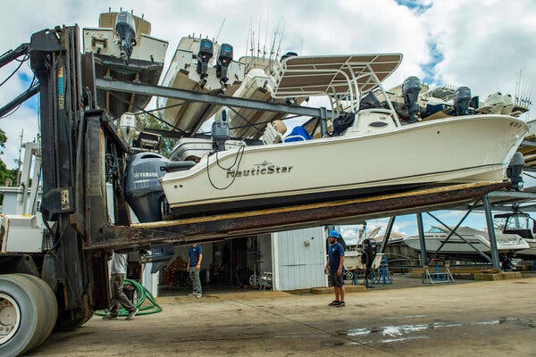 Boats being taken out of the water at Safe Harbor Marina in Buzzards Bay, Mass., on Friday in preparation for Hurricane Henri.