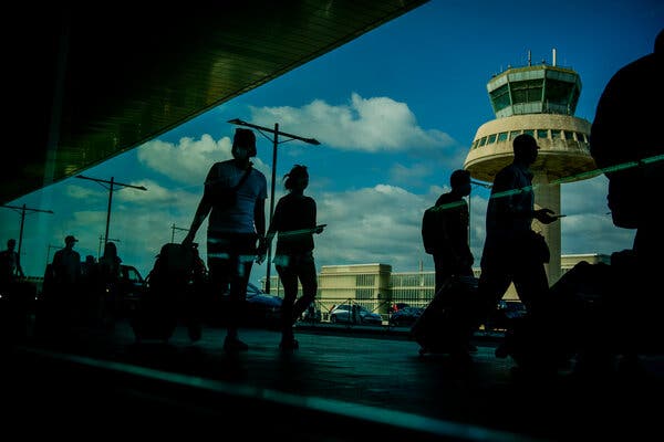 Passengers carried luggage at the Barcelona airport, Spain, Friday, July 9, 2021.