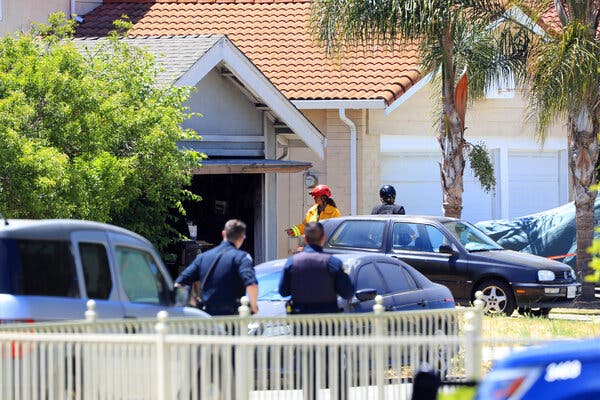 First responders walk the street in front of a home that was set ablaze in San Jose.