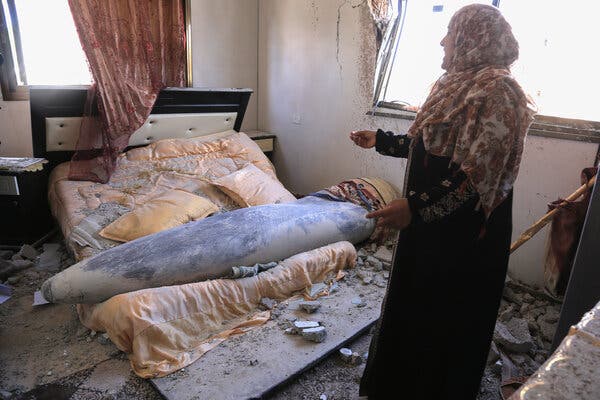 Amna Hadayed standing next to an unexploded Israeli bomb that fell inside her daughter’s home on Thursday in Khan Younis, southern Gaza.