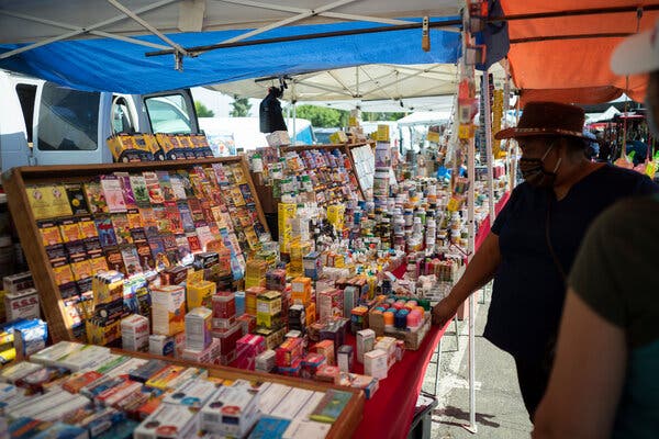 Many immigrants, who are suspicious of the coronavirus vaccine and fear government help, have been sold fraudulent Covid therapies at flea markets like the Cherry Avenue Auction in Fresno, Calif.