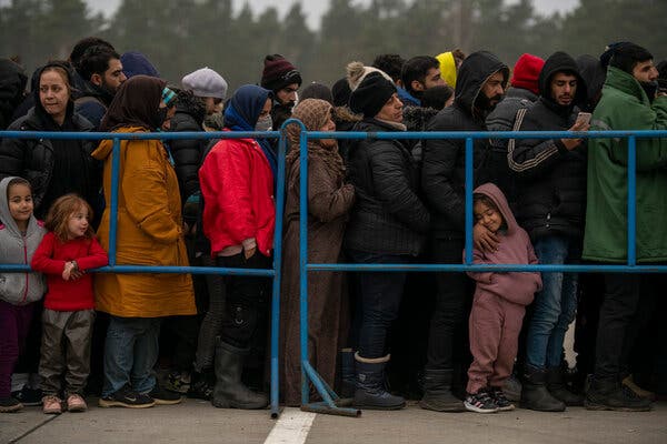 Migrants lining up for tea from the Belarusian Red Cross and Emergency Ministries at a logistics center close to the Belarus-Polish border at Bruzgi on Wednesday.