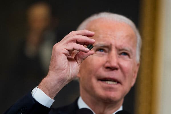 President Biden holding a semiconductor, which have been in short supply during the pandemic, at the White House in February.
