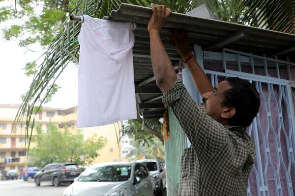 Sasikumar, 45, a car cleaner who lost his job during the lockdown, hanging a white flag outside his home in Kuala Lumpur, Malaysia’s capital, on Monday.
