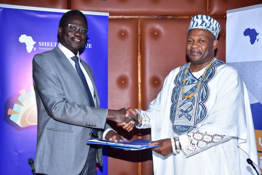 Triangle Real Estate Chief Executive Officer Amb. Arop Deng Kuol, and Shelter Afrique Chief Executive Officer Andrew Chimphondah exchange documents after signing the USD1.5bn housing deal.