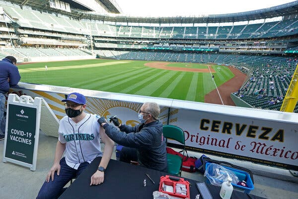 A vaccination clinic before a baseball game on Tuesday in Seattle. Washington is one of many states that is reducing the number of vaccine doses it requests from the federal government.