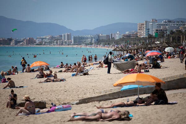 Tourists enjoying the beach at the Spanish Balearic Island of Mallorca, Spain, this month.