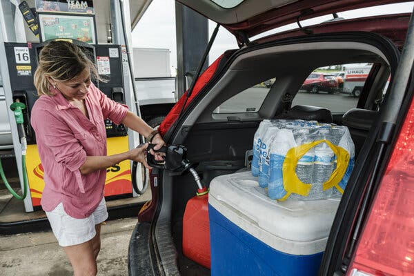 Preparing for Hurricane Ida in Pass Christian, Miss., with gasoline and bottled water.
