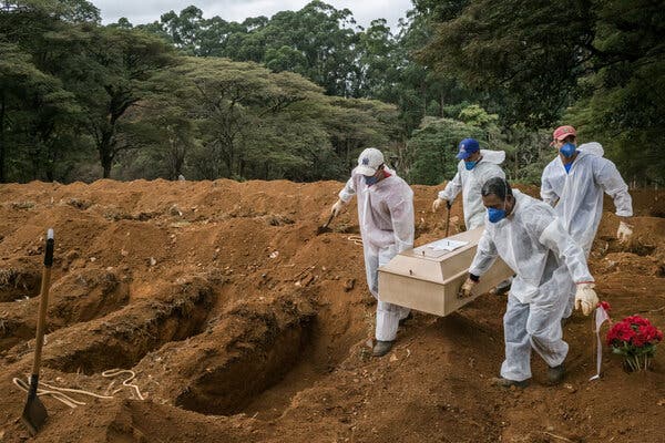 Gravediggers carrying the coffin of a Covid-19 victim during a burial in São Paulo, Brazil, in May.