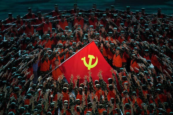 Performers gathering around a Communist Party flag during a gala show in Beijing on Monday ahead of the 100th anniversary of the founding of the Chinese Communist Party.